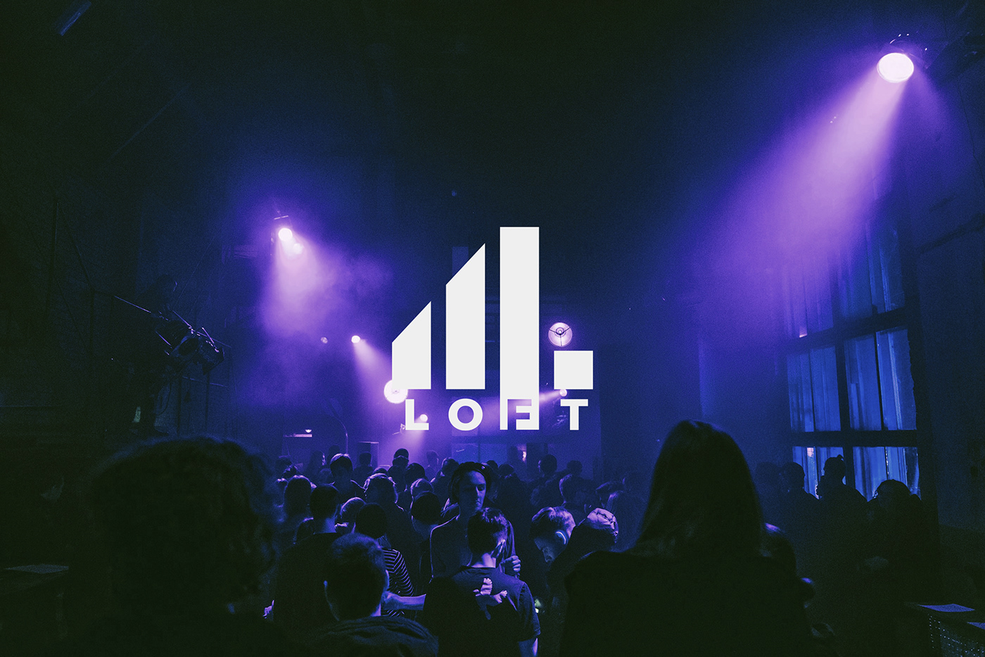 4Loft branding photograph with a crowd under violet lights